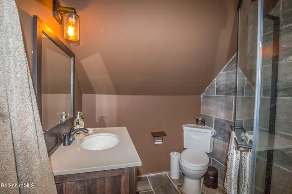 a bathroom with a sink toilet and mirror