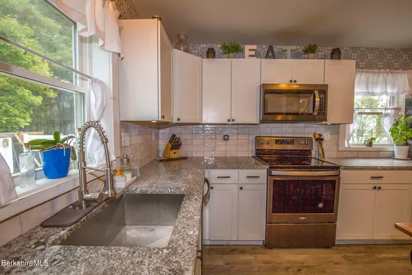 a kitchen with a stove and a microwave