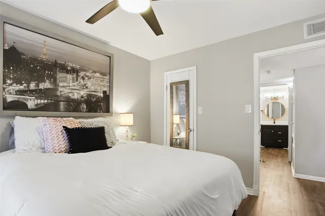 a bedroom with a large bed and a chandelier