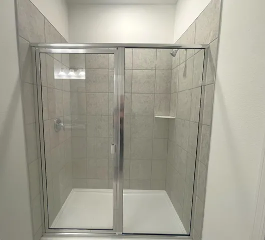 a bathroom with a glass shower door