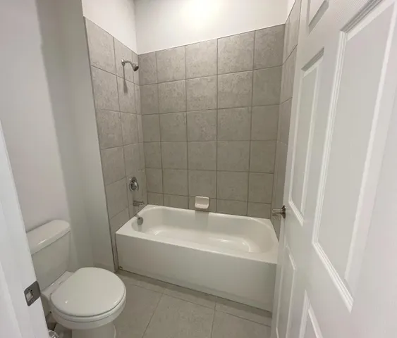 a white bath tub sitting next to a white toilet