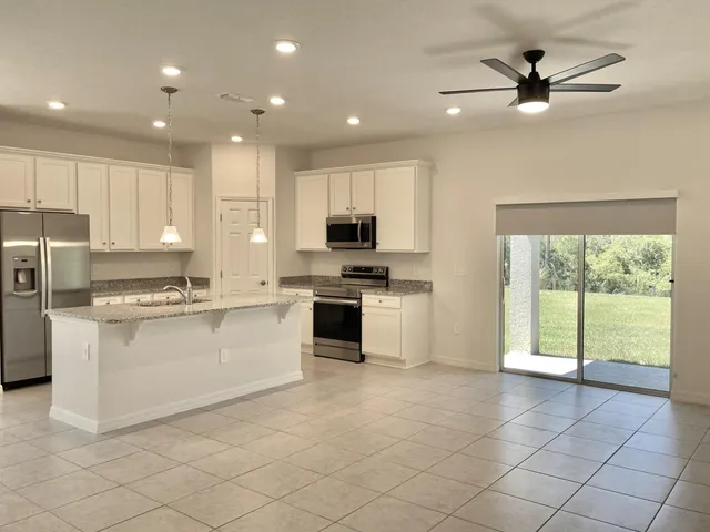 a kitchen with a stove a sink and a refrigerator