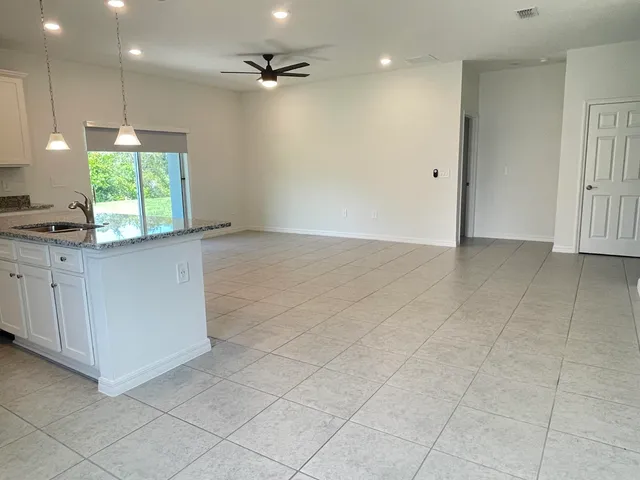 a view of a kitchen with a sink and a window
