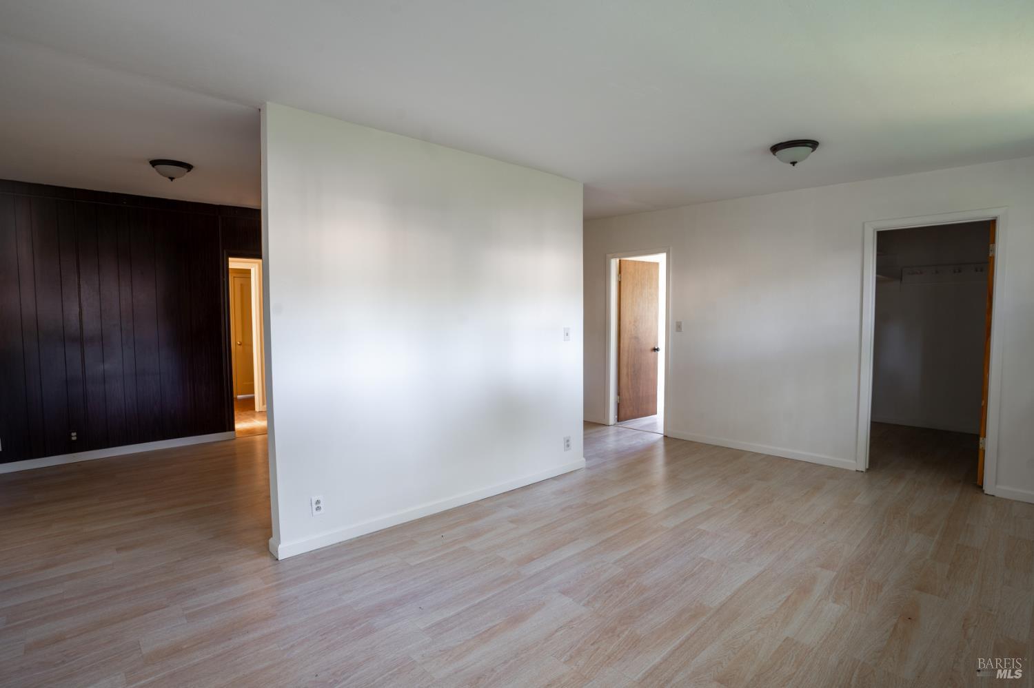 490 Cornish Lane Angwin, CA 94508 - Photo 11 of 30 an empty room with wooden floor & windows