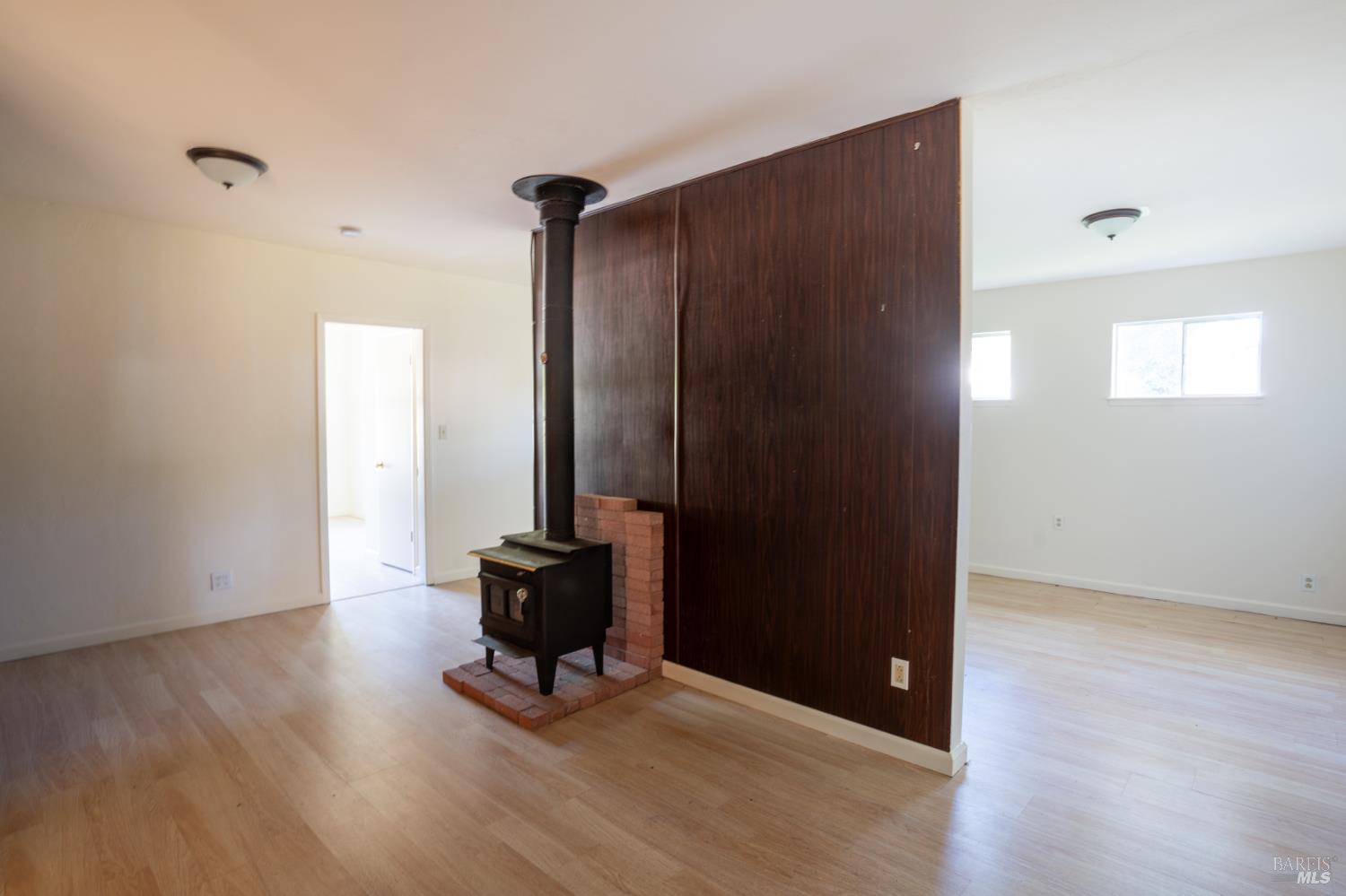 490 Cornish Lane Angwin, CA 94508 - Photo 15 of 30 an empty room with wooden floor and windows