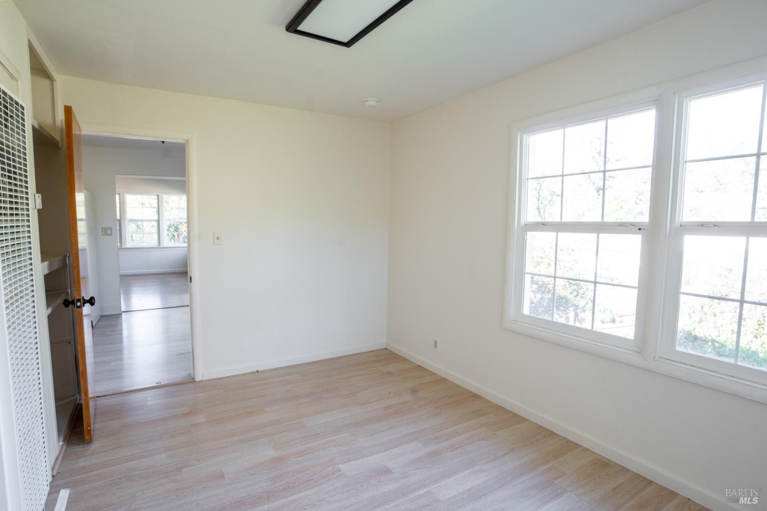 490 Cornish Lane Angwin, CA 94508 - Photo 18 of 30 an empty room with wooden floor and windows