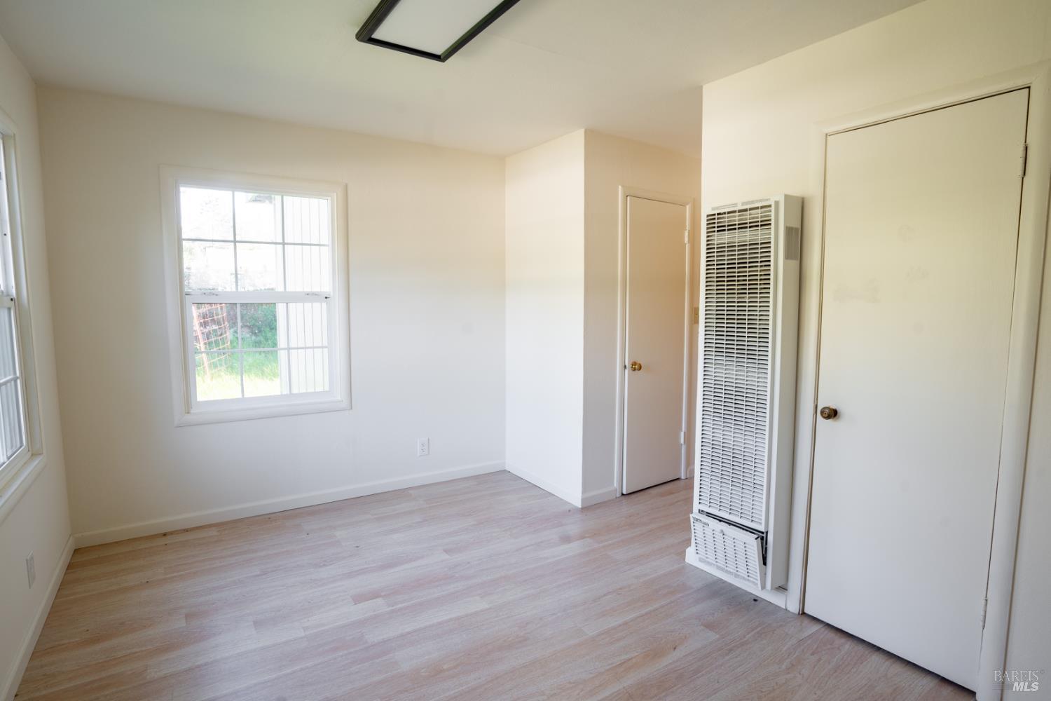 490 Cornish Lane Angwin, CA 94508 - Photo 19 of 30 an empty room with wooden floor and windows