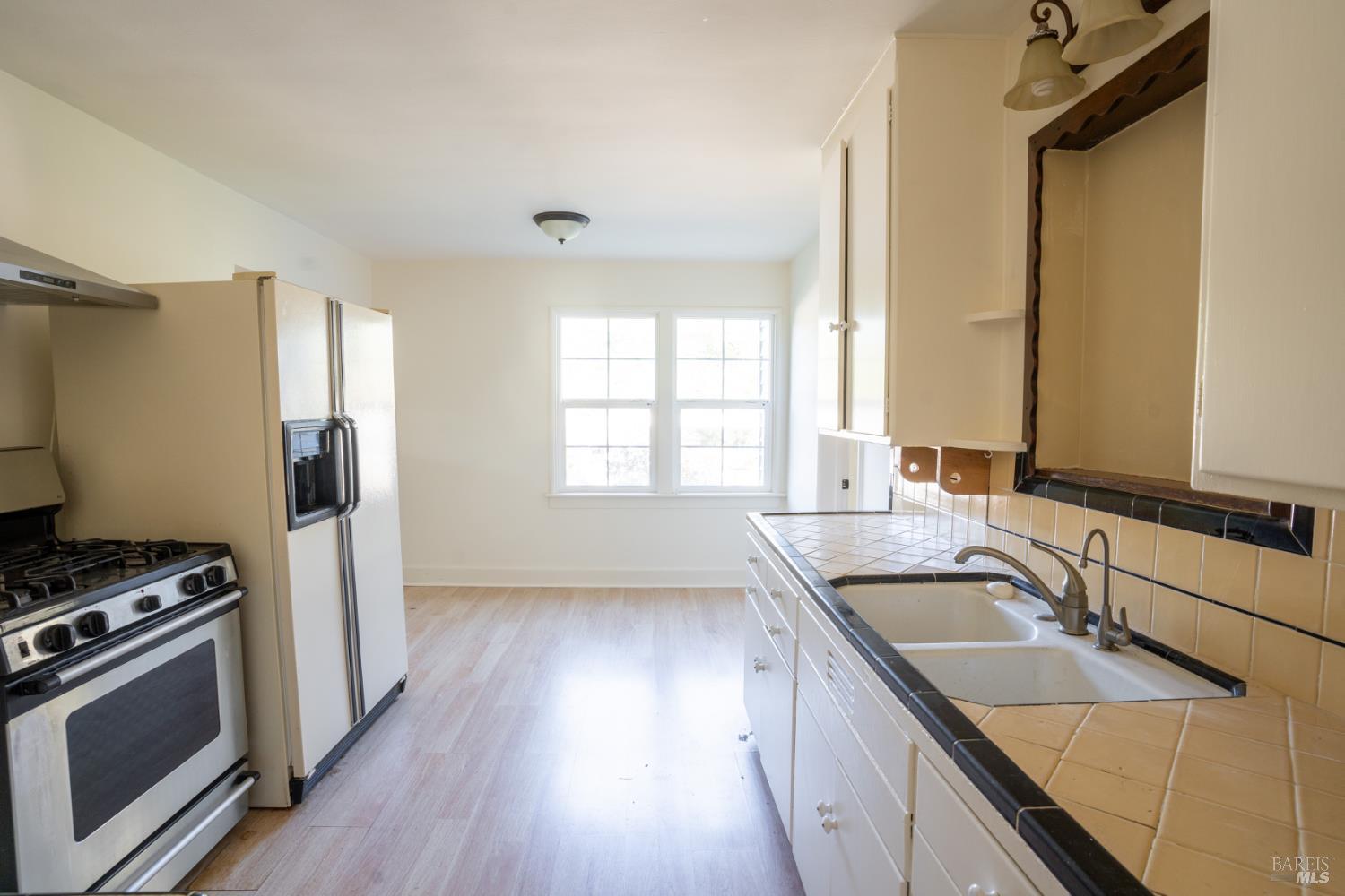490 Cornish Lane Angwin, CA 94508 - Photo 20 of 30 a kitchen with granite countertop a sink stove and refrigerator