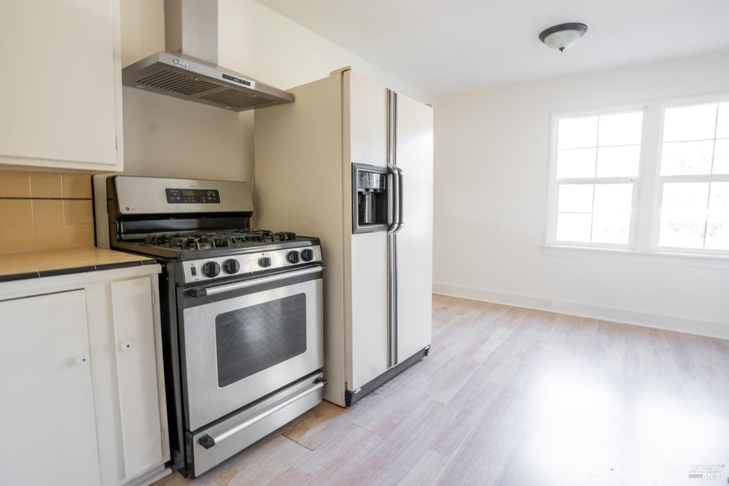 490 Cornish Lane Angwin, CA 94508 - Photo 21 of 30 a kitchen with stainless steel appliances a stove a microwave and a hard wood floor