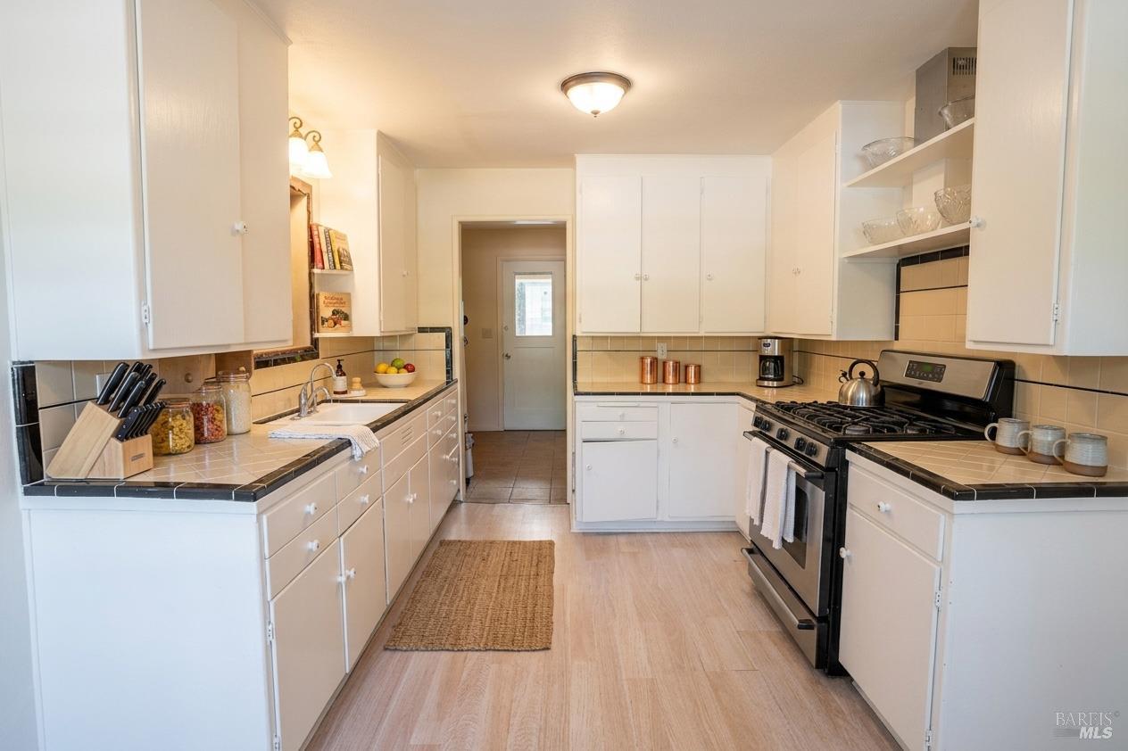 490 Cornish Lane Angwin, CA 94508 - Photo 22 of 30 a large kitchen with stainless steel appliances granite countertop a lot of counter space and wooden floors