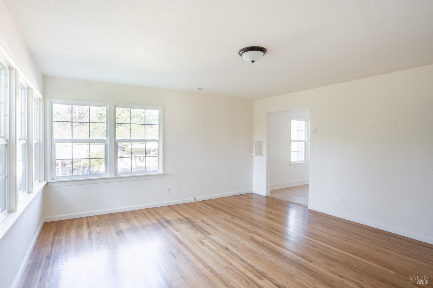490 Cornish Lane Angwin, CA 94508 - Photo 27 of 30 an empty room with wooden floor and windows