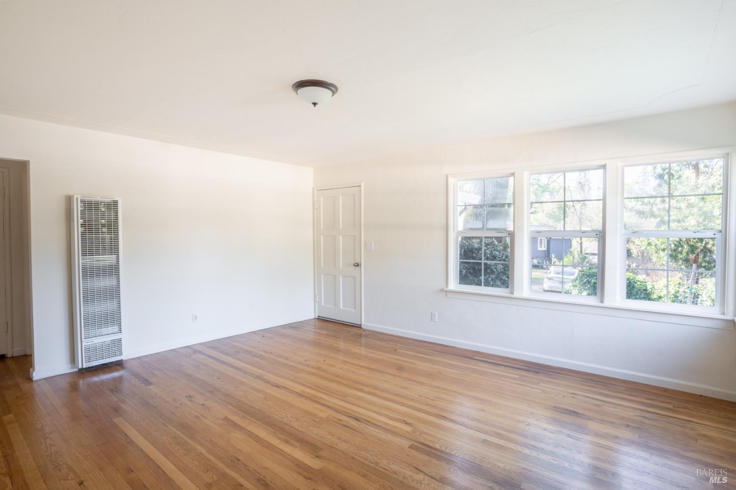 490 Cornish Lane Angwin, CA 94508 - Photo 29 of 30 a view of an empty room with wooden floor and a window