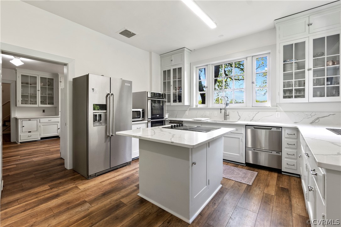 211 Ross Road Henrico, VA 23229 - Photo 20 of 50 a kitchen with stainless steel appliances granite countertop a refrigerator a sink dishwasher a stove and white countertops with wooden floor
