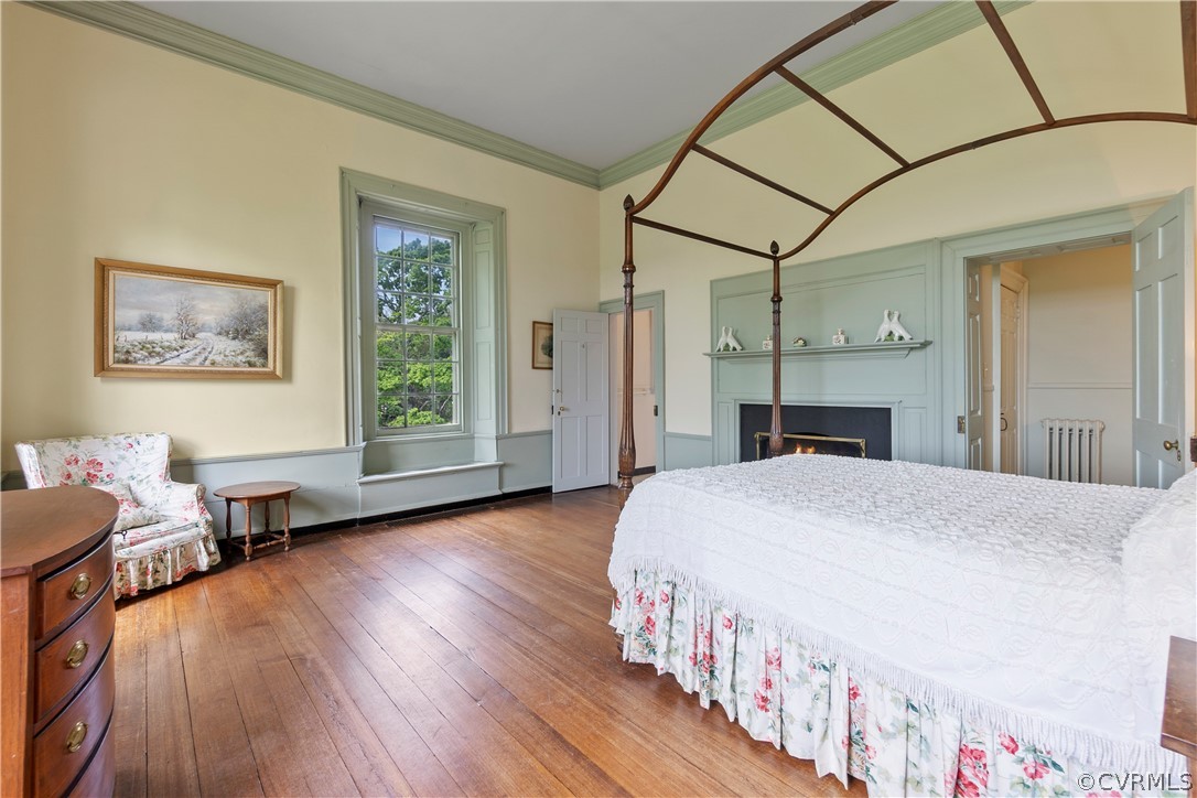 211 Ross Road Henrico, VA 23229 - Photo 38 of 50 a spacious bedroom with a bed a table and a large mirror