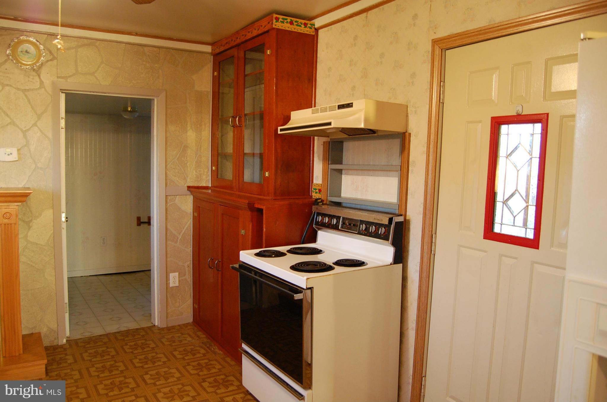 12609 Eaton Road Rocky Ridge, MD 21778 - Photo 11 of 25 a kitchen with a refrigerator and a stove