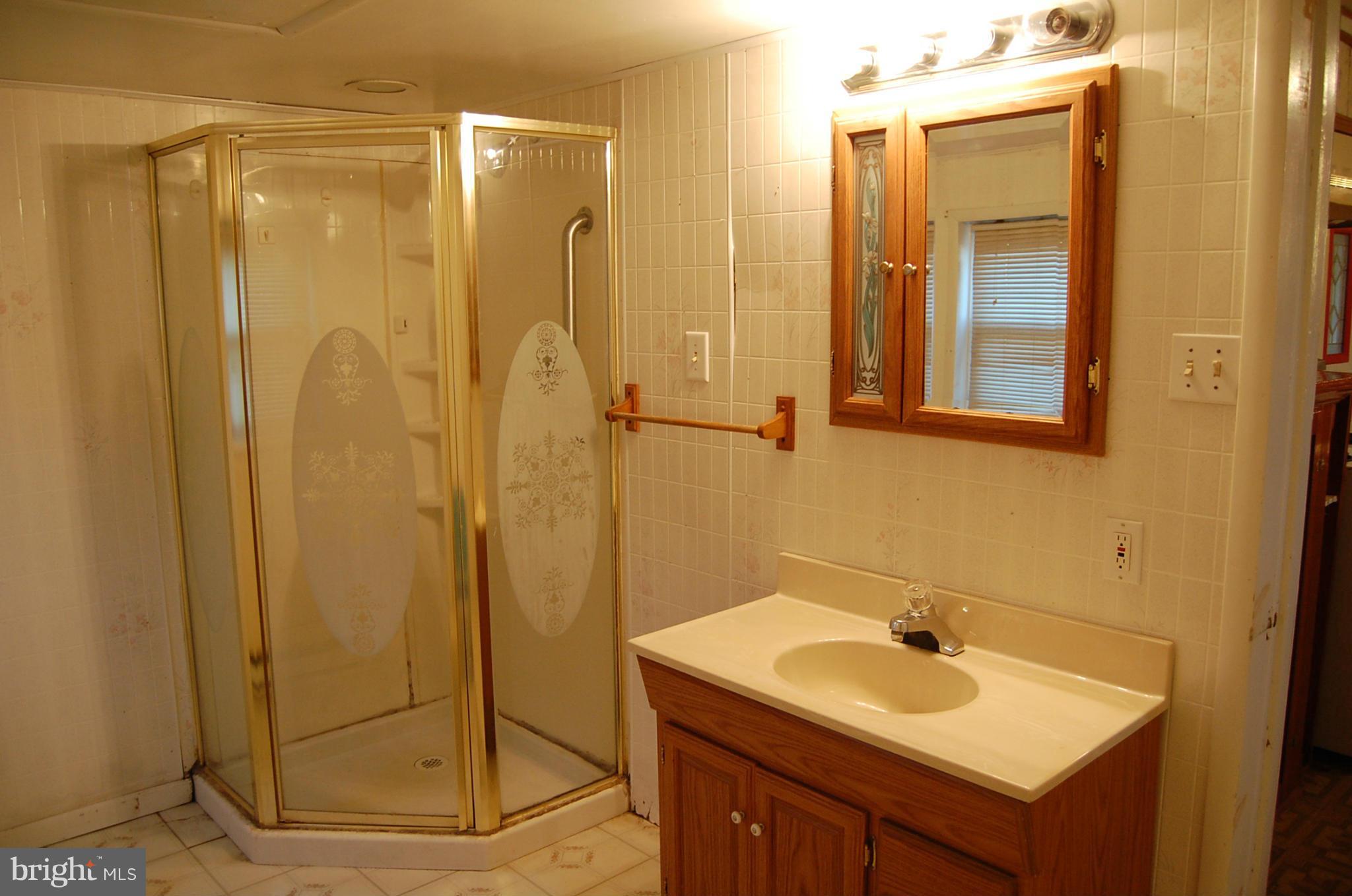 12609 Eaton Road Rocky Ridge, MD 21778 - Photo 17 of 25 a bathroom with a sink and a mirror