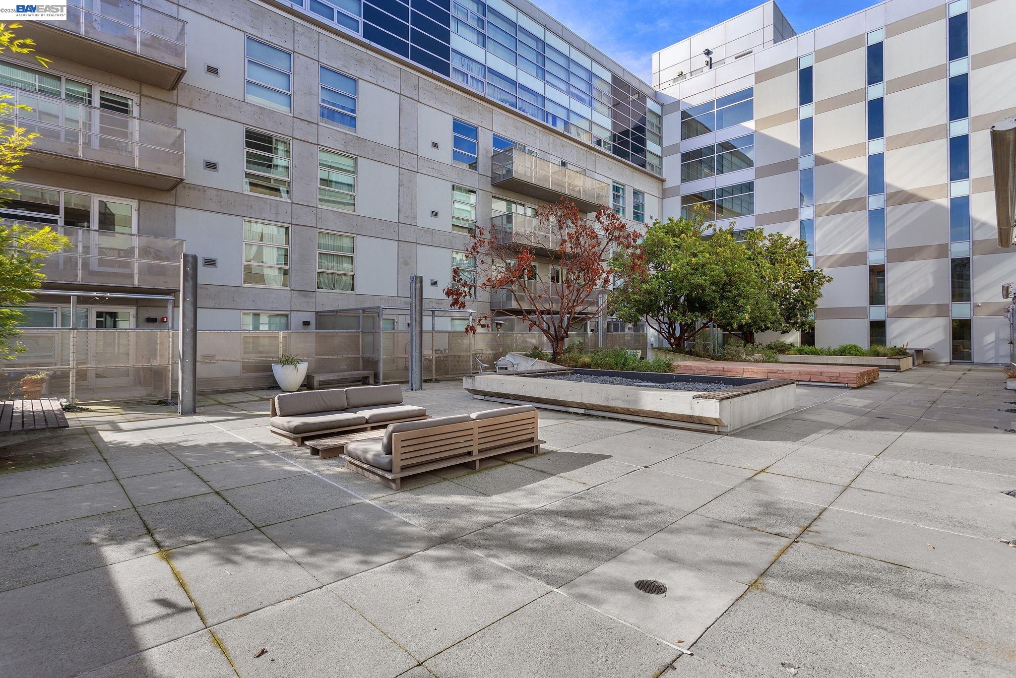 428 Alice Street, Unit 304 Oakland, CA 94607 - Photo 1 of 1 a bench is sitting in front of a building