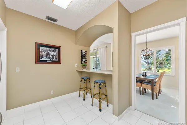 a kitchen with granite countertop a refrigerator and a stove top oven