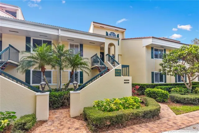 an aerial view of a house with a yard and lake view