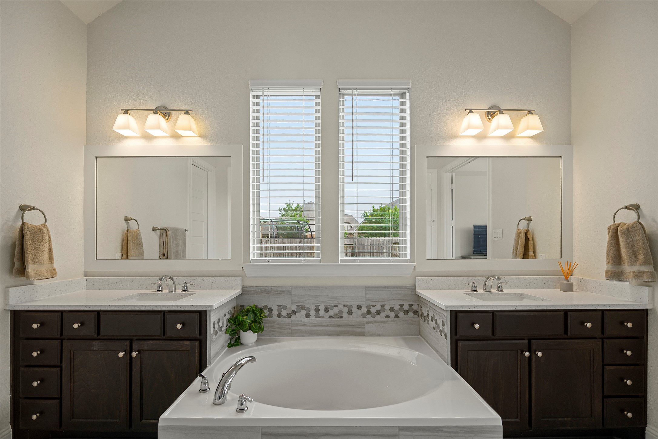 20330 Rosegold Way Spring, TX 77379 - Photo 9 of 48 Spa-inspired primary bath featuring separate vanities and a centrally positioned soaking tub.