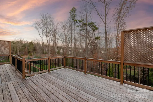 a view of balcony with wooden floor and fence