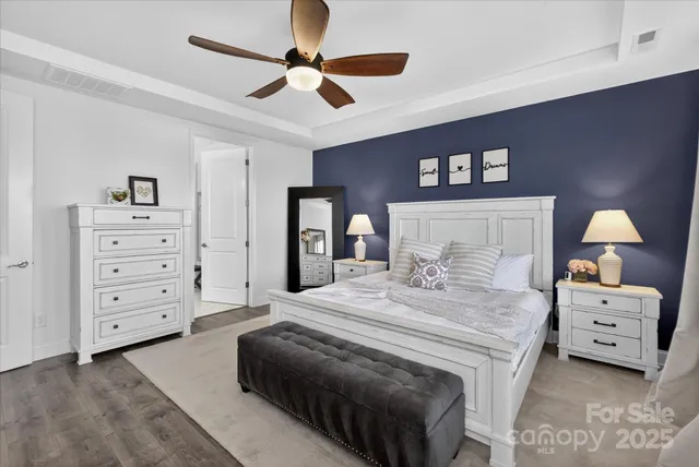 a bedroom with a bed and a ceiling fan