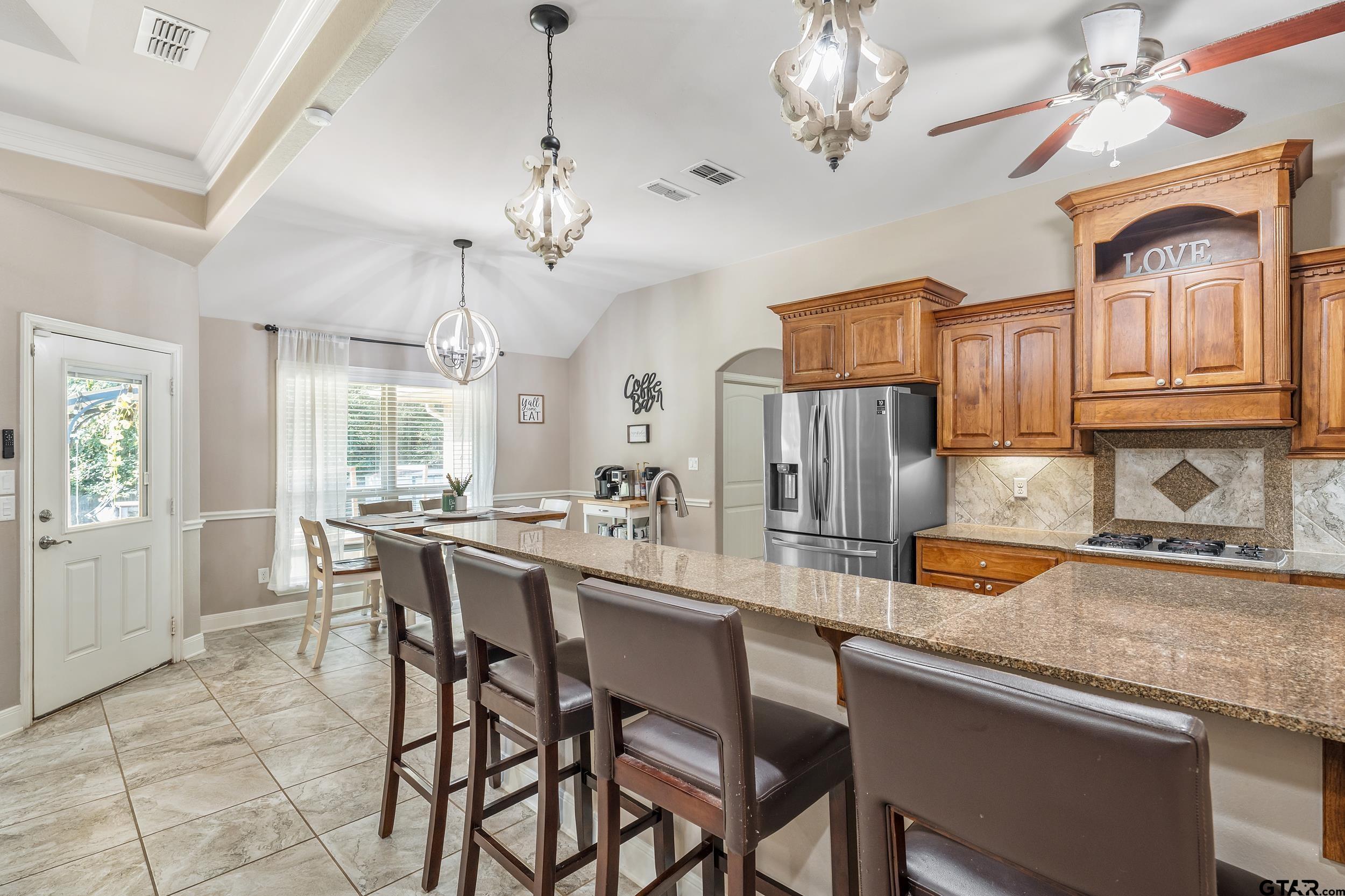 19499 Sara Lane Flint, TX 75762 - Photo 11 of 31 a view of a dining room with furniture a chandelier and kitchen view