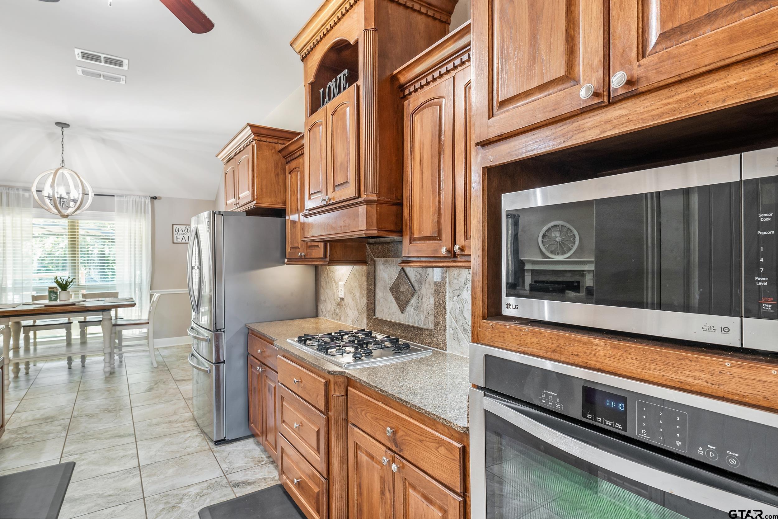 19499 Sara Lane Flint, TX 75762 - Photo 13 of 31 a kitchen with stainless steel appliances granite countertop a stove a refrigerator and a cabinets