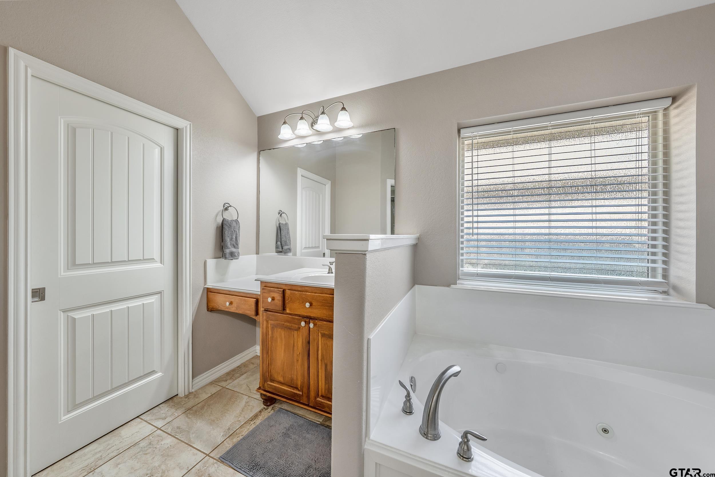19499 Sara Lane Flint, TX 75762 - Photo 17 of 31 a bathroom with a tub sink and mirror
