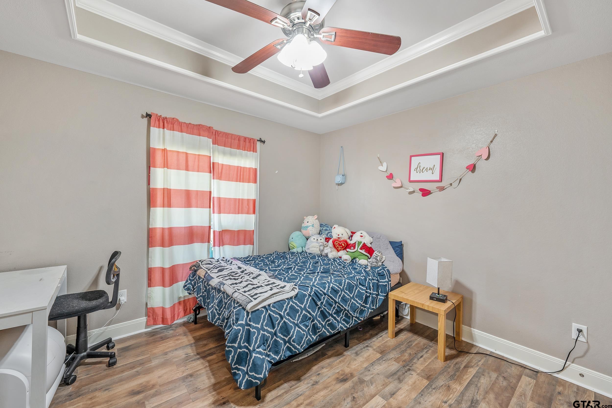 19499 Sara Lane Flint, TX 75762 - Photo 20 of 31 a bedroom with a bed and a chandelier