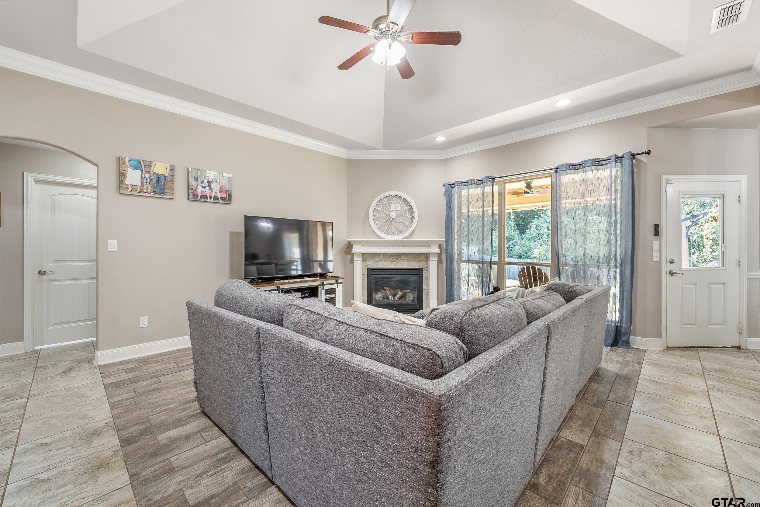 19499 Sara Lane Flint, TX 75762 - Photo 6 of 31 a living room with furniture a fireplace and a flat screen tv