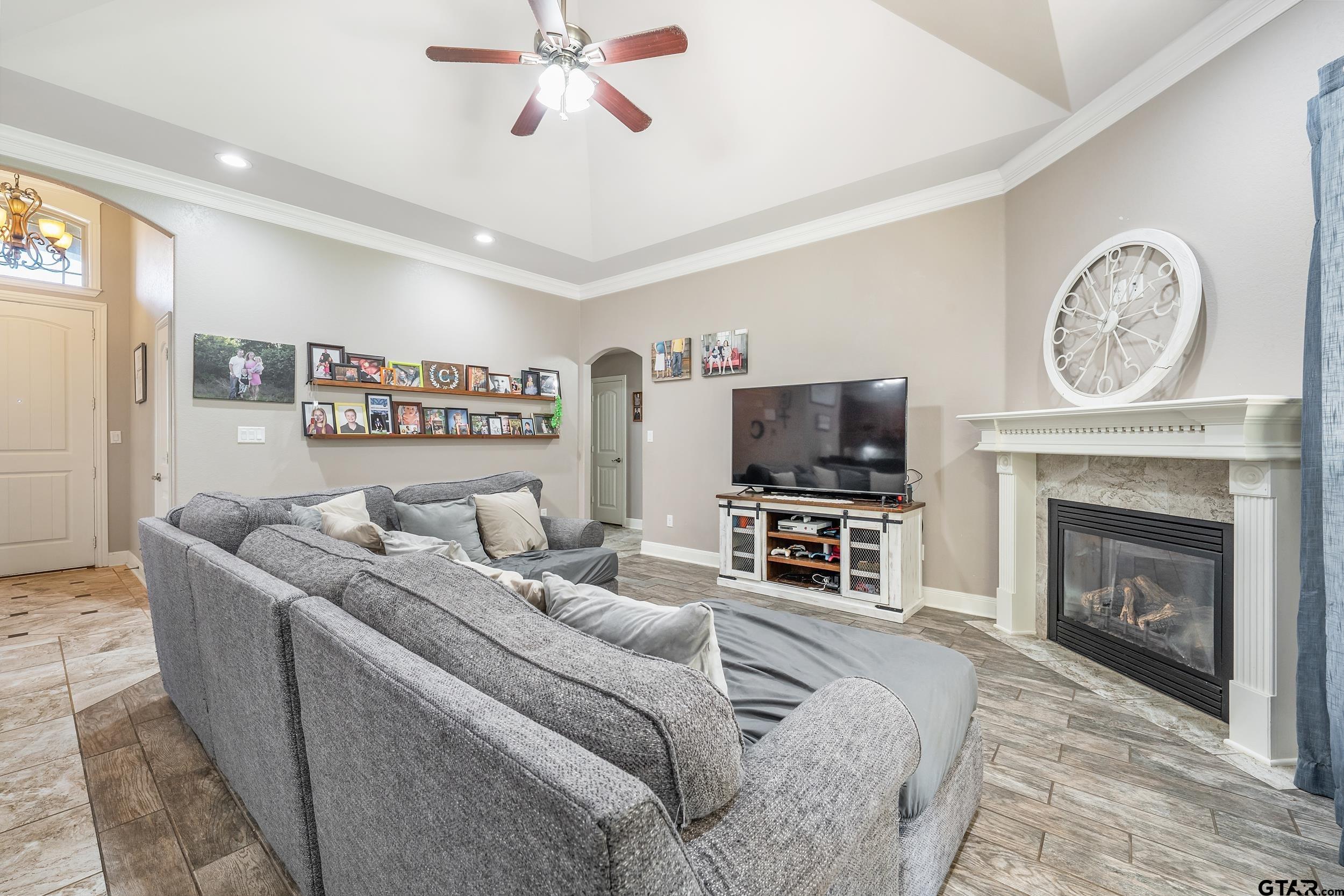 19499 Sara Lane Flint, TX 75762 - Photo 7 of 31 a living room with furniture a flat screen tv and a fireplace
