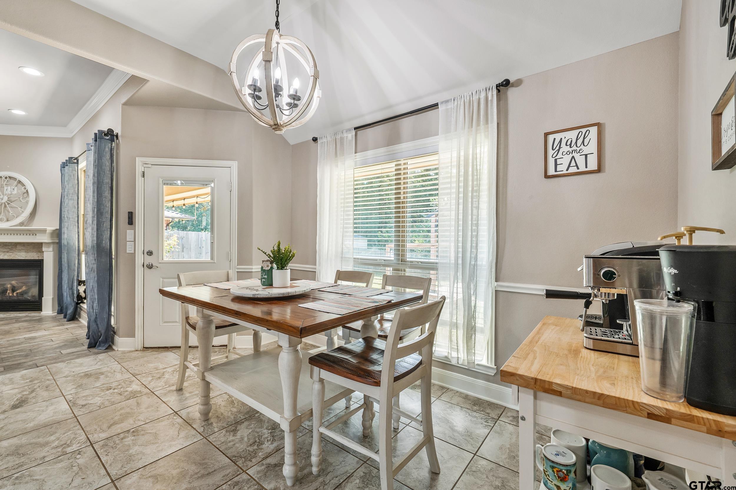 19499 Sara Lane Flint, TX 75762 - Photo 9 of 31 a view of a dining room with furniture a chandelier and wooden floor