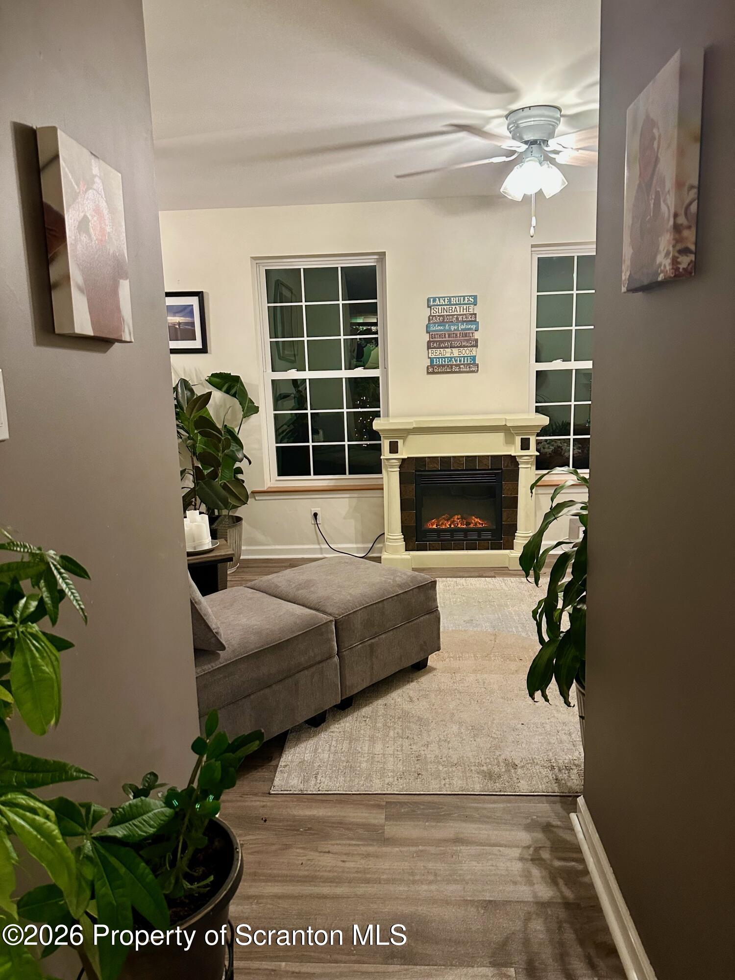 155 Baylor Road Nicholson, PA 18446 - Photo 33 of 53 a living room with a couch a fireplace and a potted plant