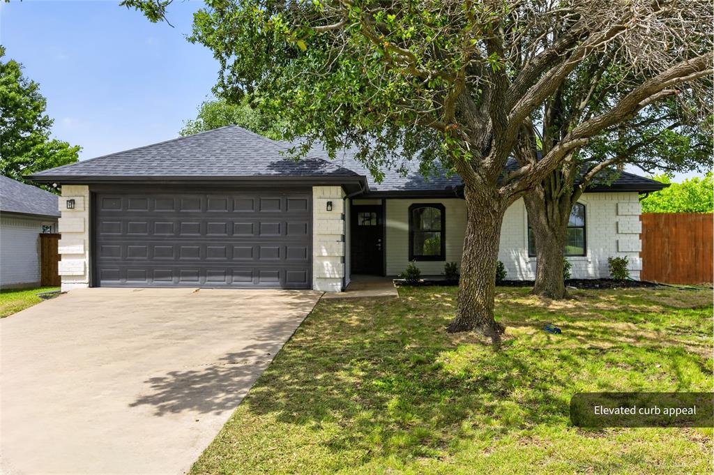 509 Brookside Court Burleson, TX 76028 - Photo 16 of 18 a front view of a house with a garden