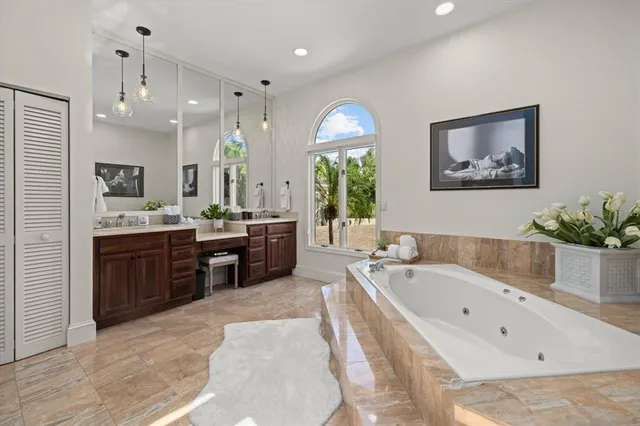 a bedroom with a bed couch and a chandelier