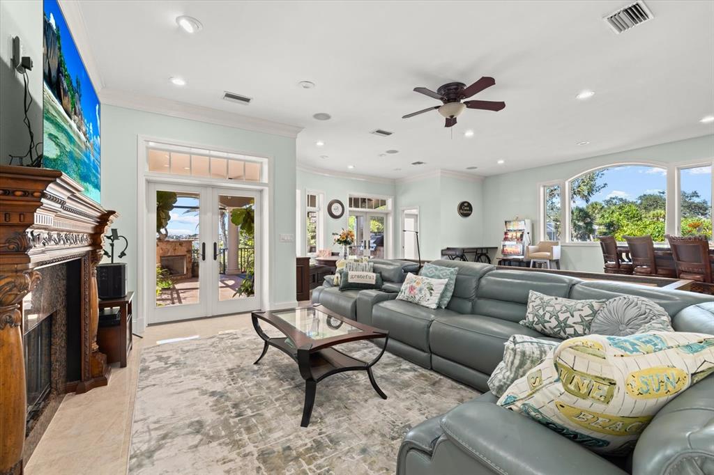 2115 Lychee Lane Nokomis, FL 34275 - Photo 17 of 85 a living room with furniture a fireplace and a flat screen tv