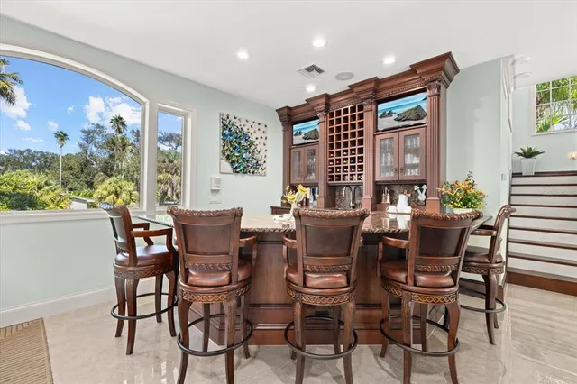 a bathroom with a granite countertop sink and a toilet