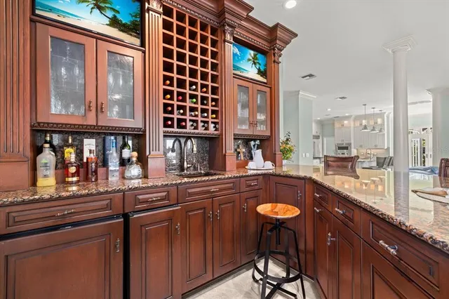 a kitchen with stainless steel appliances granite countertop a sink a stove and a refrigerator