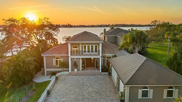 a view of a house with pool and sitting area