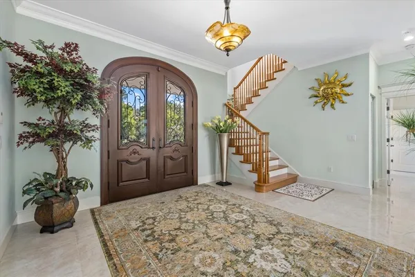 a living room with lots of furniture and a chandelier