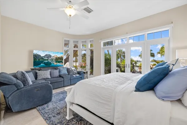 a bedroom with a bed and a chandelier