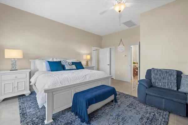 a spacious bathroom with a granite countertop toilet sink and mirror