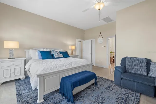 a spacious bathroom with a granite countertop toilet sink and mirror