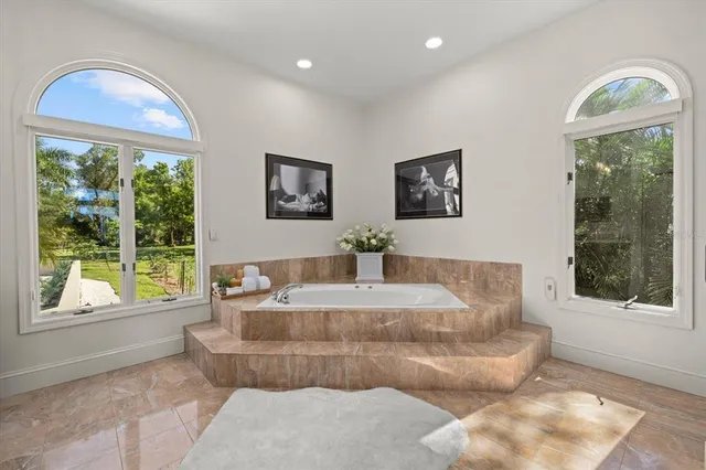 a bedroom with a bed a table and a potted plant