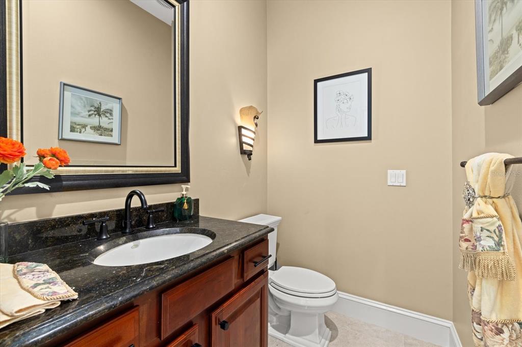 2115 Lychee Lane Nokomis, FL 34275 - Photo 37 of 85 a bathroom with a granite countertop sink and a toilet