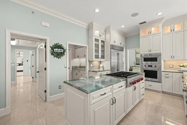 a dining room with furniture a chandelier and wooden floor