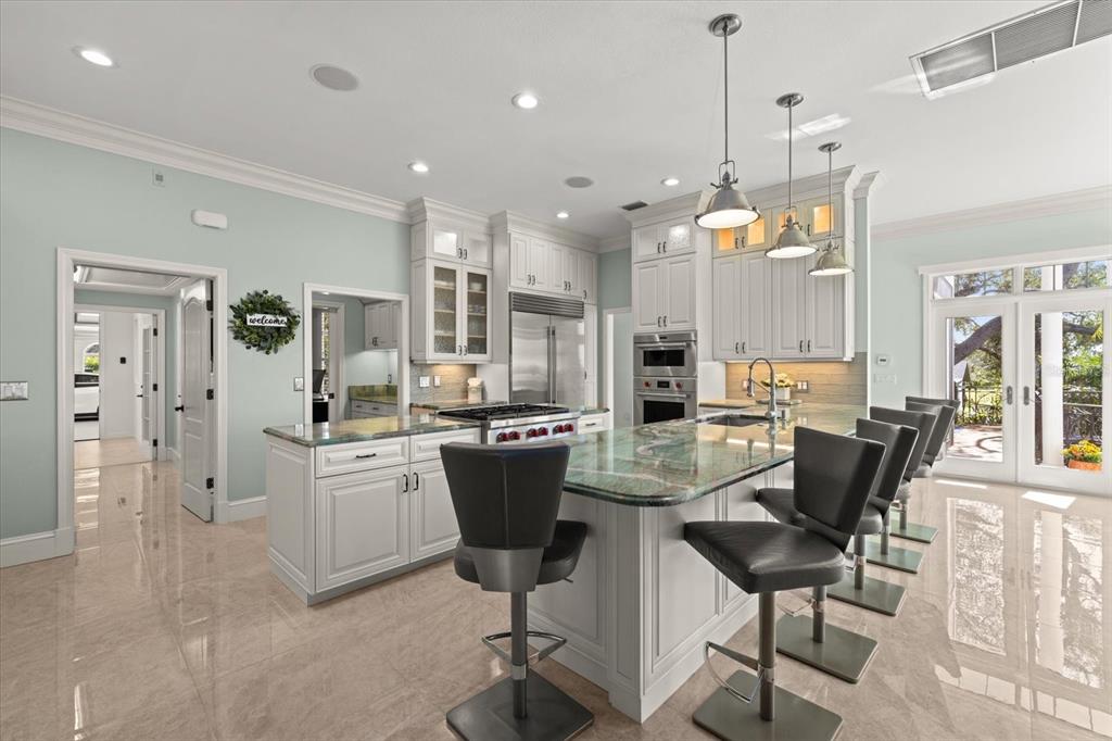 2115 Lychee Lane Nokomis, FL 34275 - Photo 42 of 85 a large kitchen with a table and chairs