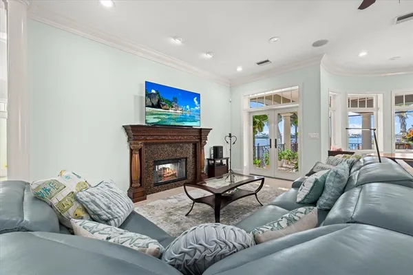 a front view of a house with a yard and potted plants