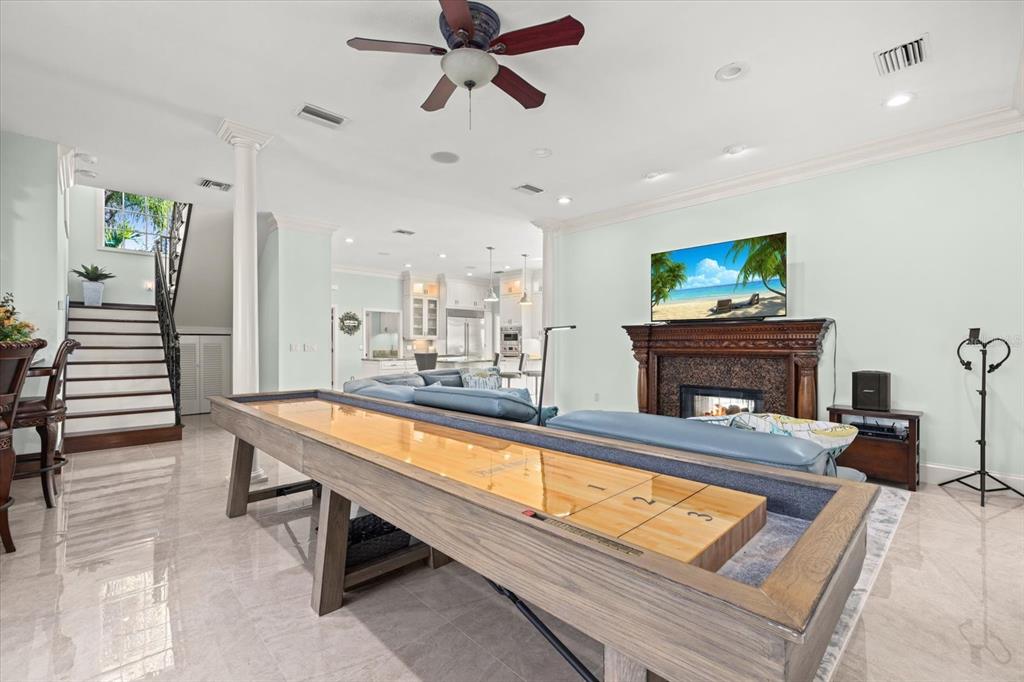 2115 Lychee Lane Nokomis, FL 34275 - Photo 49 of 85 a living room with furniture a fireplace and a flat screen tv